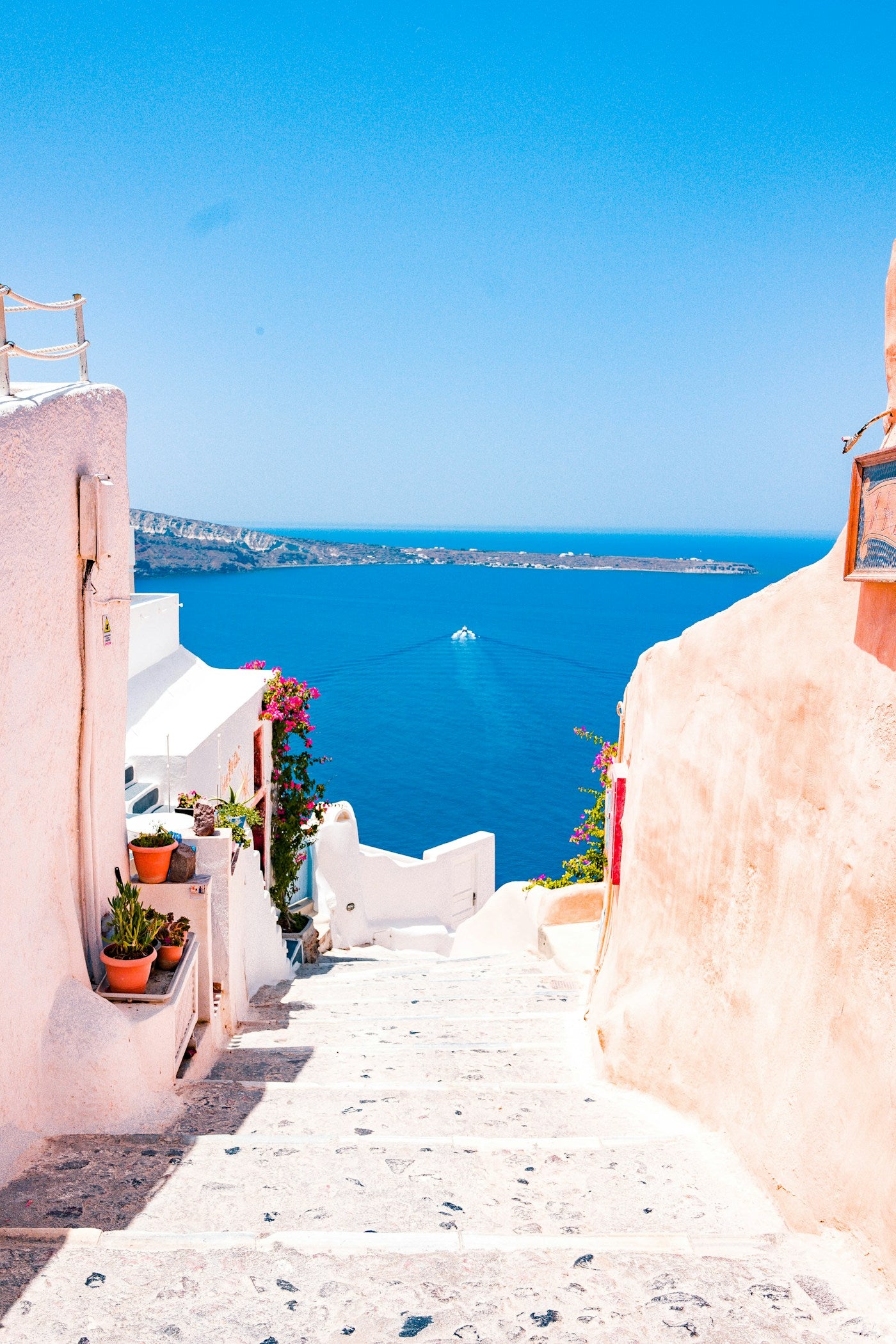 Mediterranean coastal village with blue water and white architecture — slow living travel editorial
